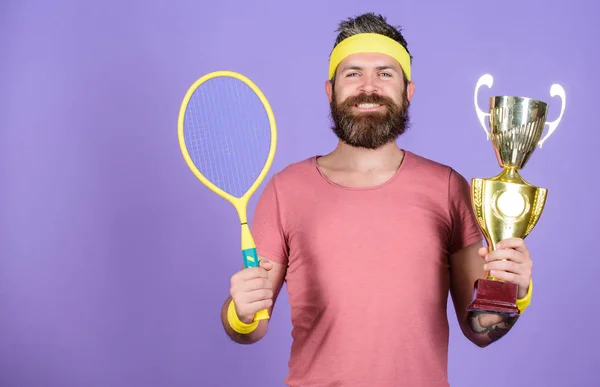 Sport achievement. Celebrate victory. Tennis champion. Athletic man hold tennis racket and golden goblet. Win tennis game. Tennis player win championship. Man bearded successful athlete. First place
