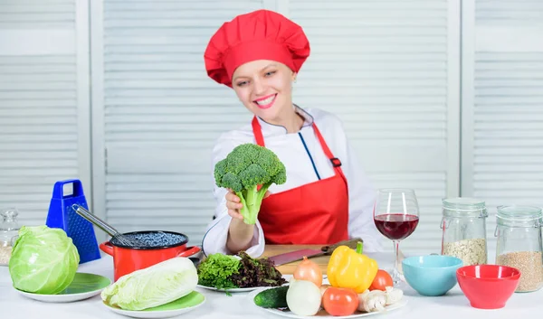 Raw food diet. Broccoli nutrition value. Woman professional chef hold raw broccoli vegetable. Free healthy vegetarian and vegan recipes. Turn broccoli into favorite ingredient. How to cook broccoli