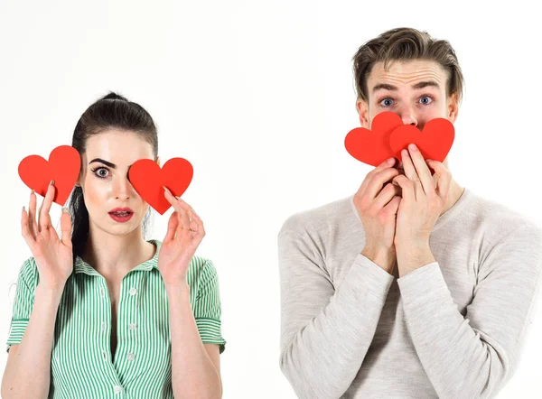 Una pareja romántica enamorada. Hombre guapo y chica guapa enamorada. Concepto de sentimientos románticos. Día de San Valentín y amor. Hombre y mujer pareja enamorada sostienen tarjetas de San Valentín corazón rojo sobre fondo blanco — Foto de Stock