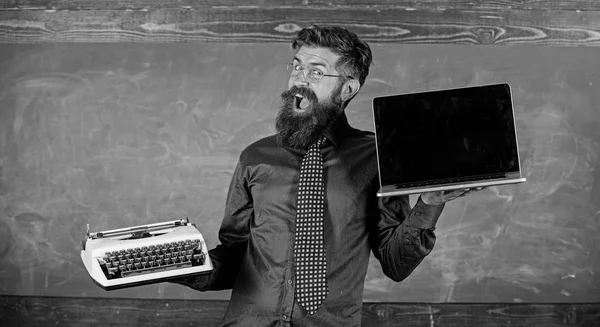 Choose right teaching method. Modern instead outdated. Teacher bearded hipster holds typewriter and laptop. Teacher choosing teaching approach. Digital against retro. Modern technologies benefit