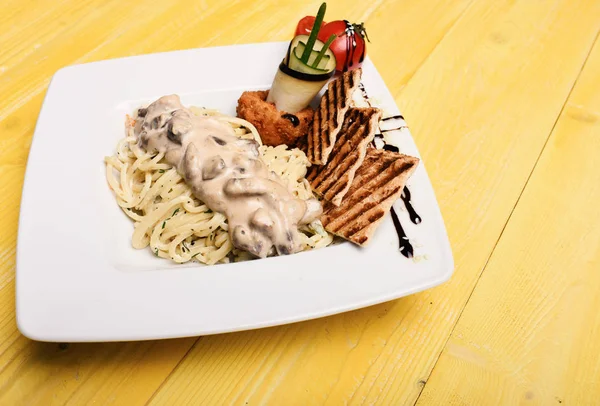 Main course concept. Pasta with white sauce and decor