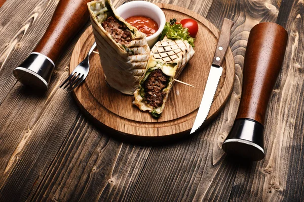 Main course concept. Minced meat wrapped with lavash