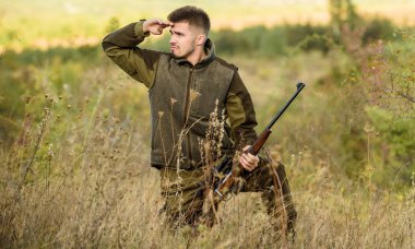Hunting permit. Bearded hunter spend leisure hunting. Hunter hold rifle. Focus and concentration of experienced hunter. Hunting and trapping seasons. Man brutal gamekeeper nature background clipart