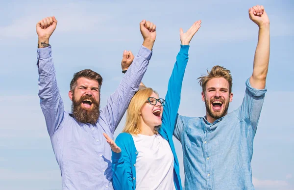 Employees enjoy feeling of freedom. Freedom concept. Men with beard in formal wear and blonde in eyeglasses finished work. Company three happy colleagues office workers enjoy freedom, sky background