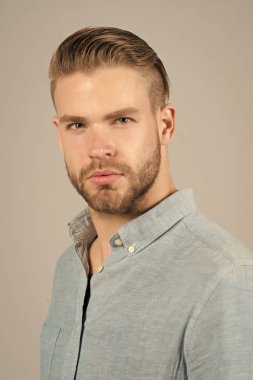 Mavi gömlekli sakallı adam. Tıraşsız yüzü deri üzerinde sakallı adam. Cilt Bakımı ve Saç Bakımı güzellik salonu. Moda veya stil ve eğilim. Güven ve karizma