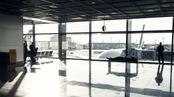 For for flight in airport at big window glass. Tourist passengers with suitcase, luggage in lounge hall. Wanderlust, vacation, travel — Stock Photo, Image