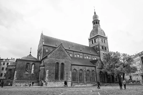 Old city architecture concept. Architectural heritage. Old or ancient church or cathedral with many window made out of red brick. Tower cross on top of roof. Central city square ancient architecture — Stock Photo, Image