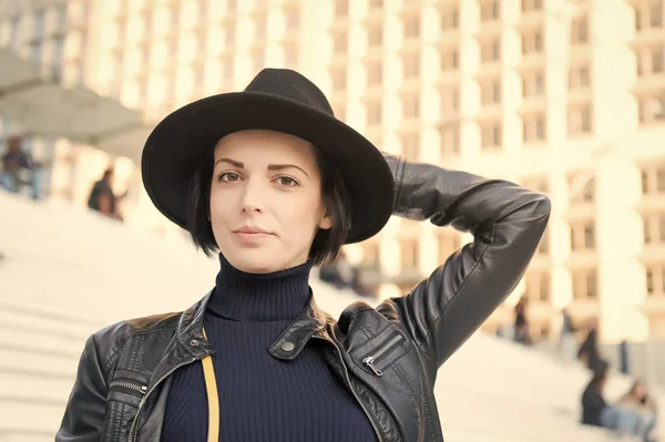 Sensual woman with brunette hair, hairstyle. Woman in black hat pose on stairs in paris, france, fashion. Beauty, look, makeup. Fashion, accessory, style. Skincare, youth, visage