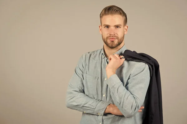 Formal menswear concept. Man bearded strict face wears formal clothes, grey background. Guy bearded attractive with hairstyle. Man with beard unshaven guy looks handsome and well groomed businessman