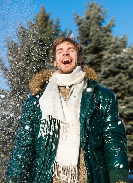 Hipster walk snowy winter day. Snowflakes in air on bright winter day. Winter fashion concept. Man unshaven wear warm jacket with fur and scarf snowy nature background. Guy enjoy sunny winter day — Stock Photo, Image