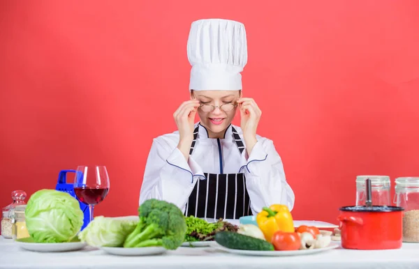 Woman chef cooking healthy food. Fresh vegetables ingredients for cooking meal. Culinary school concept. Female in apron knows everything about culinary art. Culinary education. Culinary expert