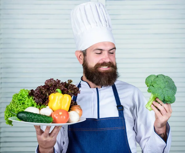 Hard choice. Vegetarian salad with fresh vegetables. Healthy food cooking. Mature hipster with beard. Cuisine culinary. Vitamin. Dieting organic food. Happy bearded man. chef recipe