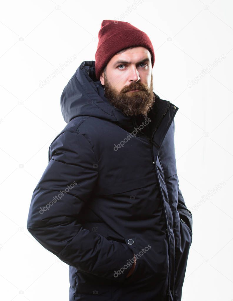 Guy wear hat and black winter jacket. Hipster style menswear. Hipster outfit. Man bearded hipster posing confidently in warm black jacket or parka. Stylish and comfortable. Hipster modern fashion