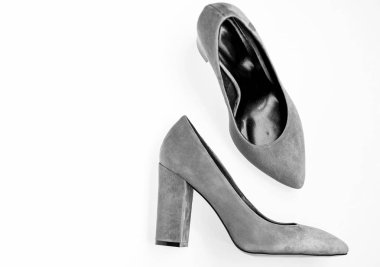 Comfortable high heels concept. Pair of fashionable high heeled shoes. Shoes made out of grey suede on white background, isolated, copy space. Footwear for women with thick high heels, top view clipart
