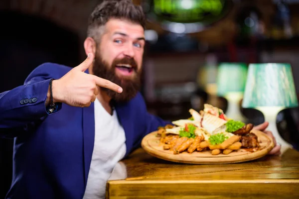 Manager formal suit sit at bar counter. Man received meal with fried potato fish sticks meat. Delicious meal. Enjoy meal. High calorie snack. Cheat meal concept. Hipster hungry eat pub fried food