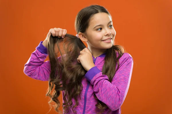 Charming beauty. Girl active kid with long gorgeous hair. Strong and healthy hair concept. How to treat curly hair. Easy tips making hairstyle for kids. Comfortable hairstyle for active lifestyle