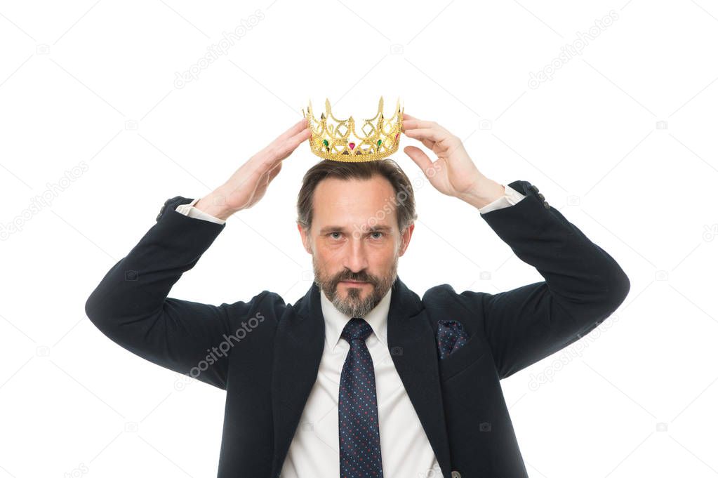 He is noble every inch of him. Mature businessman trying on crown. Fit for a king. Business king. Senior man representing power. Success in business. King of style. Achieving victory and success