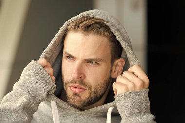Sakallı ve çekici bir adam başlık takıyor. Erkeklik kavramı. Ciddi bir yüzü olan, şehirli geçmişi olan, dağılmış bir adam. Sakallı ya da traşsız adam yakışıklı görünüyor.