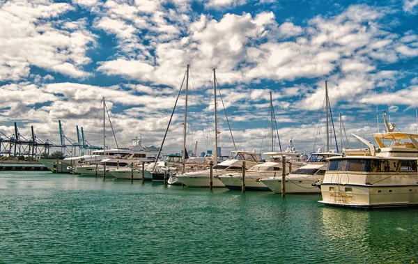 Miami, USA - February 19, 2016: yachts and sail boats in sea port on cloudy blue sky. Yachting and sailing. Luxury travel on boat. Summer vacation on sea. Water transport and vessel — Stock Photo, Image