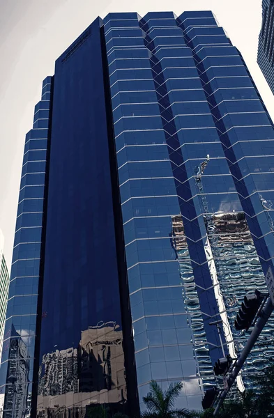 Miami, USA - October 30, 2015: tower building with glass facade on blue sky. Architecture and design. Success and future concept. Commercial property or real estate — Stock Photo, Image