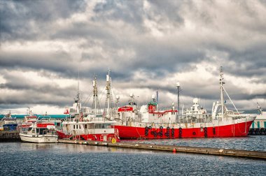 Reykjavik, İzlanda - 13 Ekim 2017: gemilerle liman. Deniz gemi ve tekne üzerinde Clear sky Harbor. Su ulaştırma araçları ve deniz taşımacılığı. Yolculuk tutkusu ya da macera ve seyahat