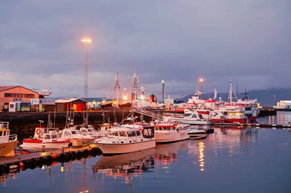 Reykjavik, Iceland - 14 oktober 2017: yachter på havet piren lights i skymningen. Segelbåtar på kusten på kvällshimlen. Vattentransporter och resor sjövägen. Semester eller reslust och reser — Stockfoto