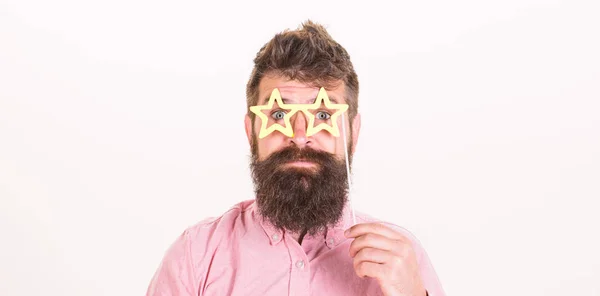Hipster in pink shirt with stylish beard isolated on white background. Handsome bearded man wearing paper star-shaped glasses, fun concept. Bearded man posing with party accessories at birthday — Stock Photo, Image