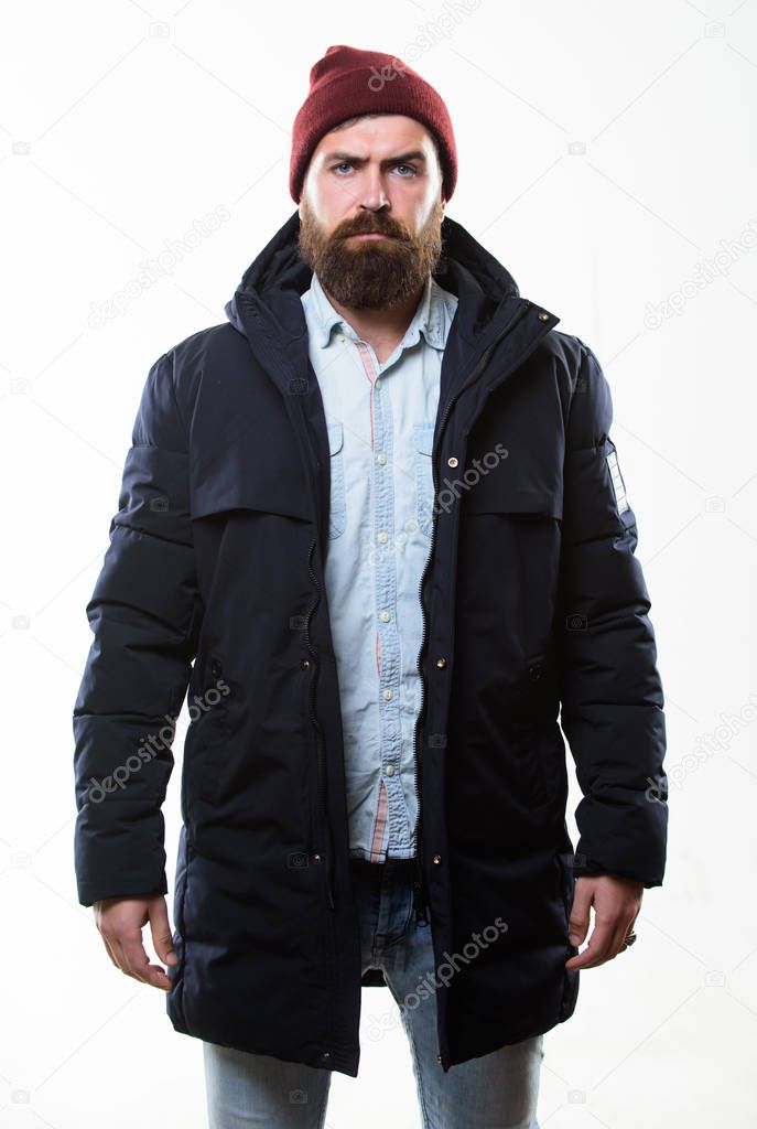 Stylish and comfortable. Man bearded hipster posing confidently in warm black jacket or parka. Hipster modern fashion. Guy wear hat and black winter jacket. Hipster style menswear. Hipster outfit
