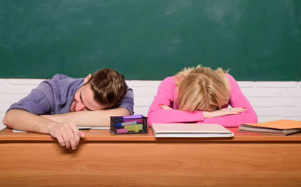 Student life issues. Guy and girl tired or lazy student lean on desk in classroom. Feeling bored. Studying in college or university. Apply for free program. Couple friends student studying university — Stock Photo, Image
