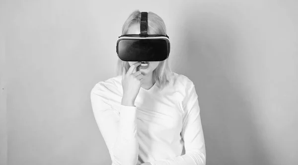 3d technology, virtual reality, entertainment, cyberspace and people concept. Person with virtual reality helmet isolated on pink background.Woman with virtual reality headset.