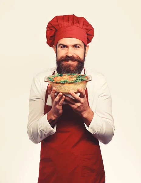 Chef holds bowl with potato casserole and parsley on top — Stock Photo, Image