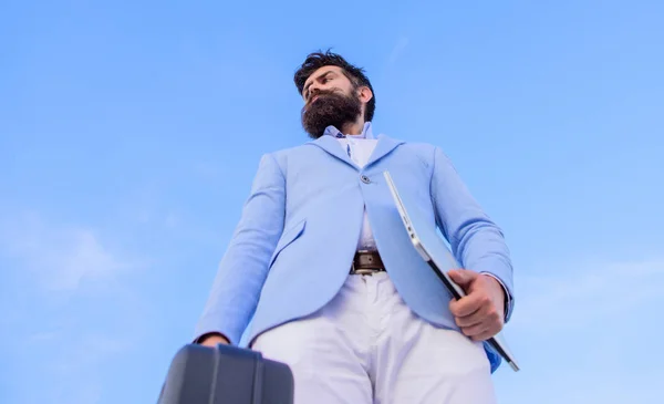 Illegal deal business. Hipster bearded face hold briefcase with bribe. Businessman presenting business case. Business man formal suit carries briefcase sky background. Entrepreneur offer bribe