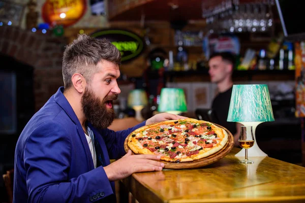 Man received delicious pizza. Cheat meal concept. Pizza favorite restaurant food. Fresh hot pizza for dinner. Hipster hungry eat italian pizza. Hipster client sit at bar counter. Enjoy your meal — Stock Image Man received delicious pizza. Cheat meal concept. Pizza favorite restaurant food. Fresh hot pizza for dinner. Hipster hungry eat italian pizza. Hipster client sit at bar counter. Enjoy your meal Royalty Free Stock Photos