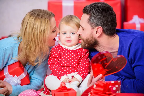 Celebrating love. Boxing day. Love and trust in family. Bearded man and woman with little girl. Happy family with present box. father, mother and doughter child. Valentines day. Red boxes