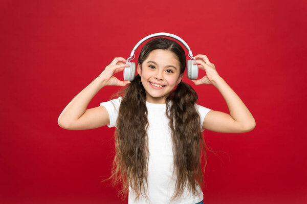 Powerful effect music teenagers their emotions, perception of world. Girl listen music headphones on red background. Modern gadget concept. Music taste. Music plays an important part lives teenagers
