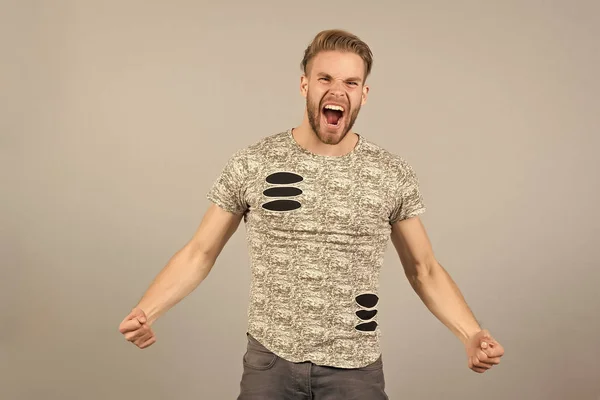 Guy bearded attractive winner lucky shouting expression. Success concept. Man with beard unshaven guy looks handsome well groomed. Man cheerful happy expression looks successfully, grey background