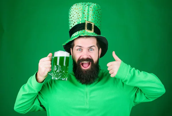 Irish pub. Highly recommend. Drinking beer celebration. Fest and holiday menu. Dyed green traditional beer. Patricks day party. Alcohol beverage. Symbol of Ireland. Man bearded hipster drink beer — Stock Photo, Image