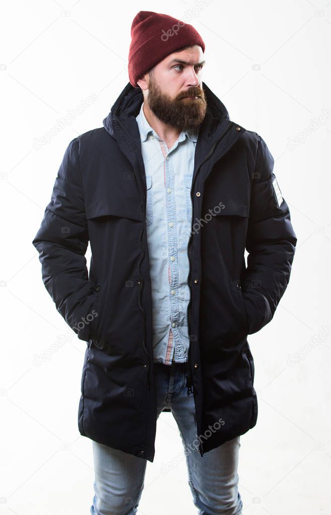 Guy wear hat and black winter jacket. Hipster style menswear. Hipster outfit. Stylish and comfortable. Man bearded hipster posing confidently in warm black jacket or parka. Hipster modern fashion