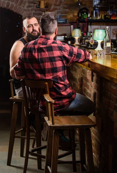 Strong alcohol drinks. Opening hours till last visitors. Friday relaxation in bar. Men relaxing at bar. Friends relaxing in bar or pub. Hipster bearded man spend leisure with friend at bar counter