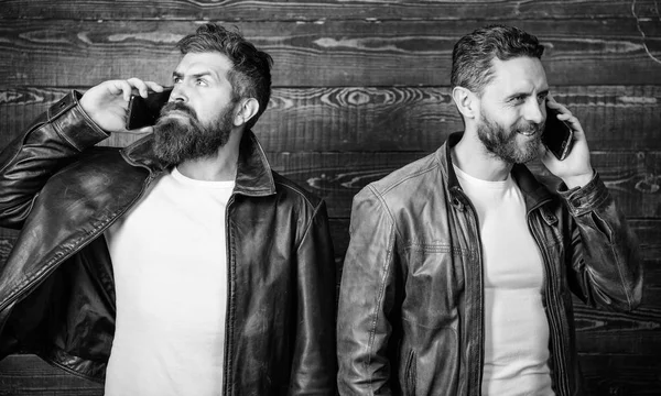 Online business. Modern technology. Men with smartphones discuss business. Mobile conversation and connect. Business call. Men brutal bearded hipster in fashionable leather jackets use mobile phone — Stock Photo, Image