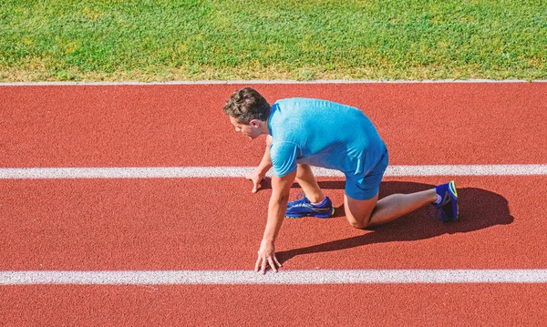 Runner ready to go. Athlete runner prepare to race at stadium. How to start running. Running tips for beginners. Man athlete stand low start position at stadium path. Beginning of new lifestyle habit — Stock Photo, Image