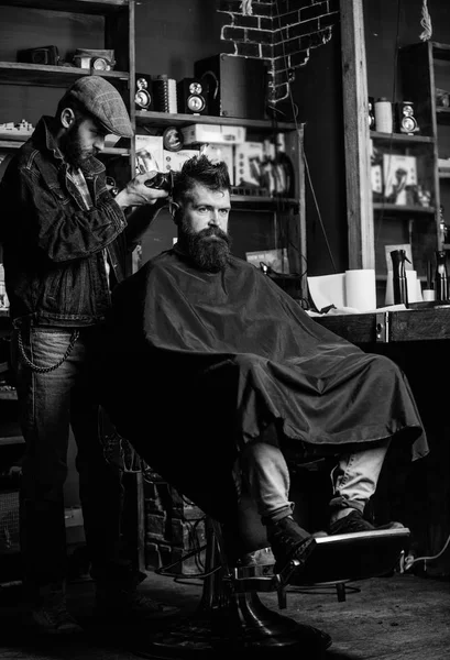 Barbeiro com clipper aparar o cabelo na nuca do cliente. Um cliente Hipster a cortar o cabelo. Barbeiro com cortador de cabelo funciona no corte de cabelo do barbeiro barbudo fundo. Conceito de penteado Hipster — Fotografia de Stock