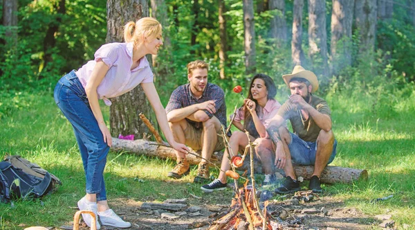Picnic with friends in forest near bonfire. Company friends having hike picnic nature background. Summer picnic. Hikers relaxing during snack time. Tourists hikers relaxing while having picnic snack