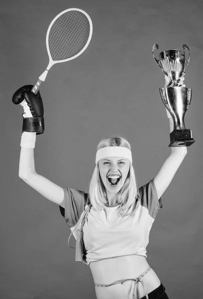 Sport equipment store. Sport shop assortment. Girl cheerful successful modern woman hold golden goblet of sport champion and equipment red background. Sport for every day. How to stay fit forever — Stock Photo, Image