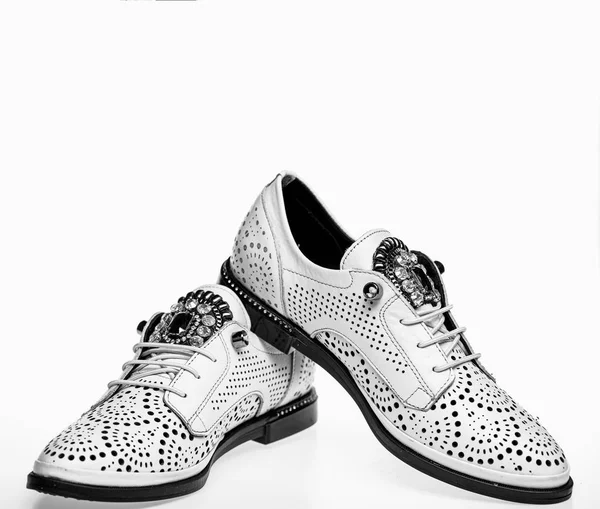 Pair of fashionable comfortable oxfords shoes. Modern shoes concept. Footwear for women on flat sole with perforation and rhinestones. Shoes made out of white leather on white background, isolated — Stock Photo, Image