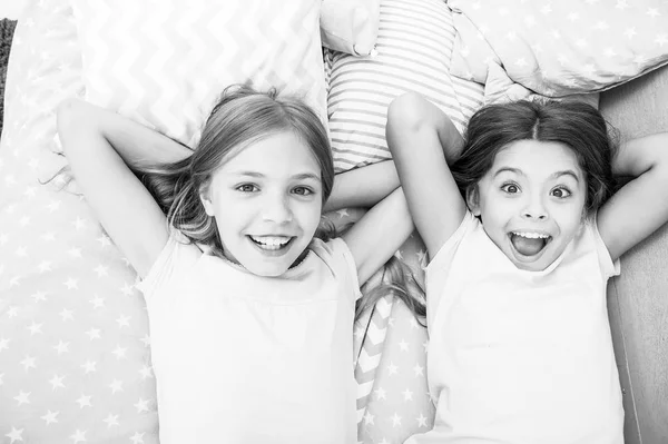 Consider theme slumber party. Slumber party timeless childhood tradition. Girls relaxing on bed. Slumber party concept. Girls just want to have fun. Invite friend for sleepover. Best friends forever