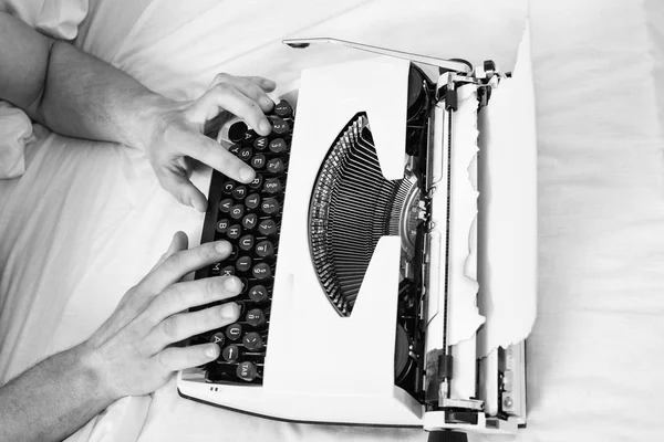 Hands writer bed white bedclothes working on new book. Writer author used to old fashioned machine instead of digital gadget. Create new chapter use typewriter. Morning inspiration concept