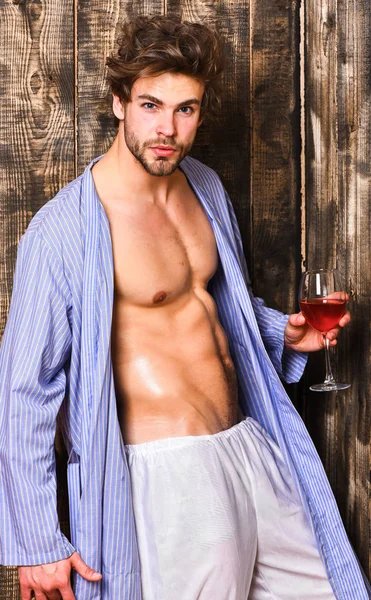 Man sexy chest sweaty skin hold wineglass. Macho tousled hair degustate luxury wine. Drink wine and relax. Erotic and desire concept. Bachelor enjoy wine. Guy attractive relaxing with alcohol drink