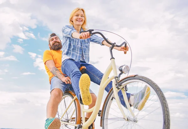 Couple with bicycle romantic date sky background. Couple in love date cycling. Explore city. Man and woman rent bike to discover city as tourist. Bike rental or bike hire for short periods of time