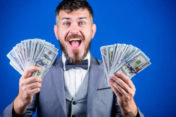 Being flush of money. Rich businessman with us dollars banknotes. Currency broker with bundle of money. Bearded man holding cash money. Business startup loan. Making money with his own business